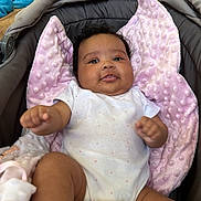 Hesma participe au concours pour gagner de l'argent avec cette photo : baby, blanket, car_seat, child, comfort, curly_hair, cushion, cute, drool, happy, indoor, infant, person, pillow, pink_blanket, portrait, relaxing, smile, soft_texture, white_onesie