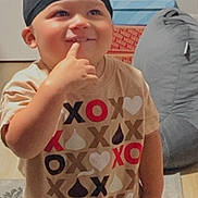 Lenox is registered to the contest to win money with this photo: bean_bag, box, carpet, casual_clothing, child, cute, floor, happy, headwear, home, indoor, light, person, playful, portrait, smiling, standing, toddler, tshirt, young_child