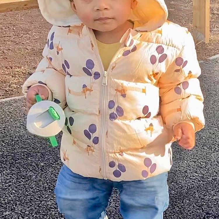 Nived joined the competition — help win amazing prizes! blue_jeans, casual, child, cute, daylight, expression, fence, footwear, gravel, hood, jacket, nature, outdoor, park, person, playful, toddler, toy, walking, young_child