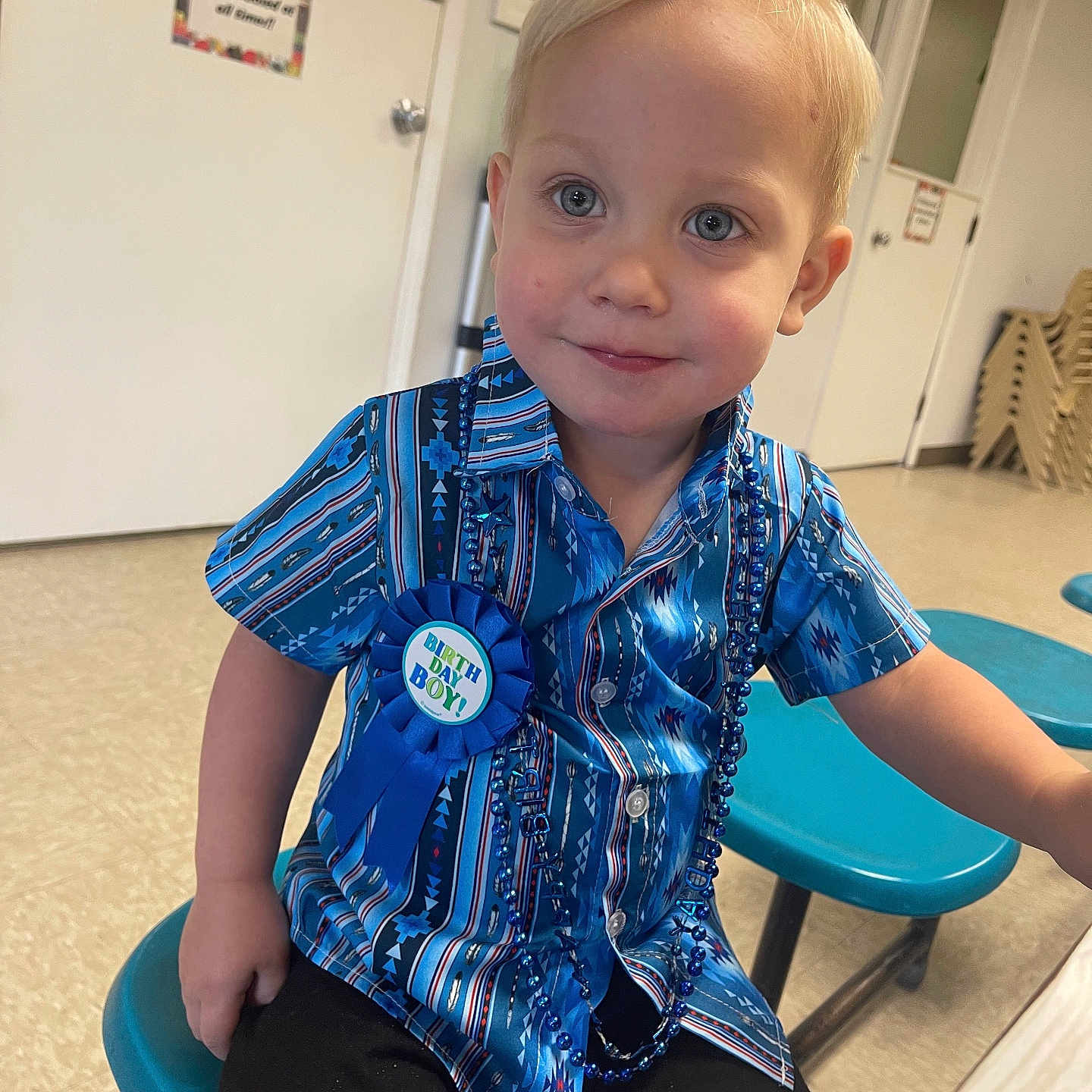 Liam joined the competition — help win amazing prizes! baby, blouse, bodypart, clothing, door, face, furniture, head, indoors, mouth, pants, person, photography, portrait, shirt, shorts, sitting, sleeve, t_shirt, table