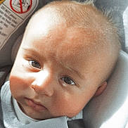 Cristian is registered to the contest to win money with this photo: baby, infant, face, car_seat, child, seatbelt, close_up, expression, light_and_shadow, soft_light, hair, skin, clothing, indoor, portrait, young_child, seat, baby_boy, cute, toddler