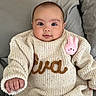 Eva Amelia joined the competition — help win amazing prizes! baby, child, infant, sweater, knitwear, plush_toy, pink, cute, portrait, face, smile, hand, cozy, indoors, fabric, couch, pillow, person, young, warm