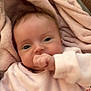 baby, blanket, child, clothing, comfort, couch, cozy, cute, expression, face, hand, indoor, infant, pink, portrait, relaxing, sleepwear, soft_texture, thumb_sucking, young