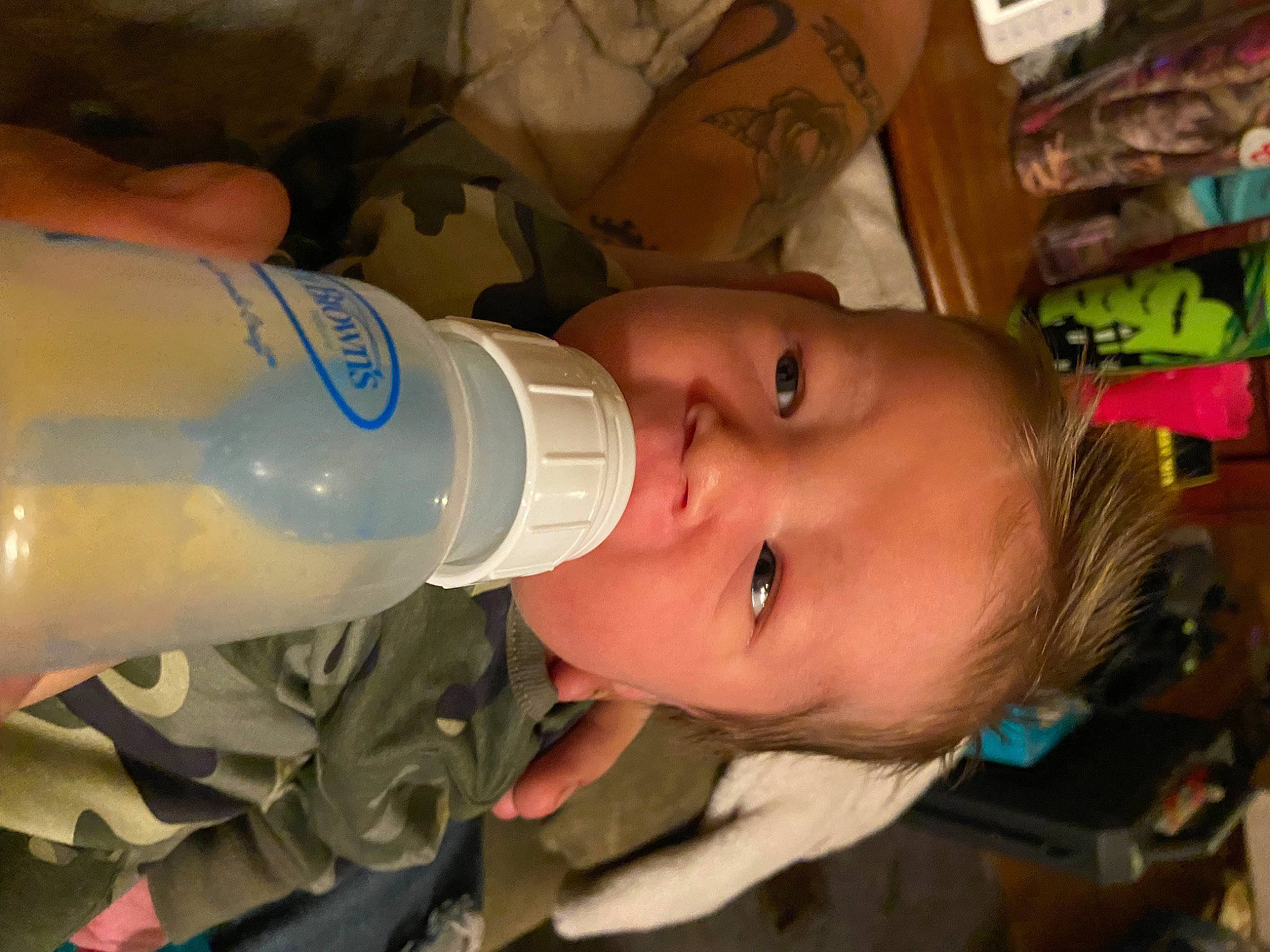 Jonathan is registered to the contest to win money with this photo: baby, baby_bottle, baby_products, bottle, cheek, child, drink, drinking, drinkware, eyelash, fluid, food, infant_formula, liquid, person, plant_milk, plastic_bottle, product, shelf, skin