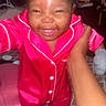 Majestic Jazelle is registered to the contest to win money with this photo: baby, child, pajamas, pink_clothing, smile, happy, indoors, bed, patterned_bedspread, person, hand, feet, face, infant, cute, holding, home, sleepwear, joy, young_child