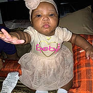 Majestic Jazelle joined the competition — help win amazing prizes! baby, child, infant, dress, headband, hand, cushion, blanket, fabric, sock, indoor, person, portrait, cute, reaching, pink, soft, sitting, tag, closeup