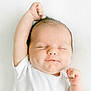baby, infant, newborn, sleeping, onesie, white_clothing, smile, dimple, closed_eyes, arm_up, fist, soft_light, minimal_background, portrait, cute, peaceful, skin, head, face, tiny