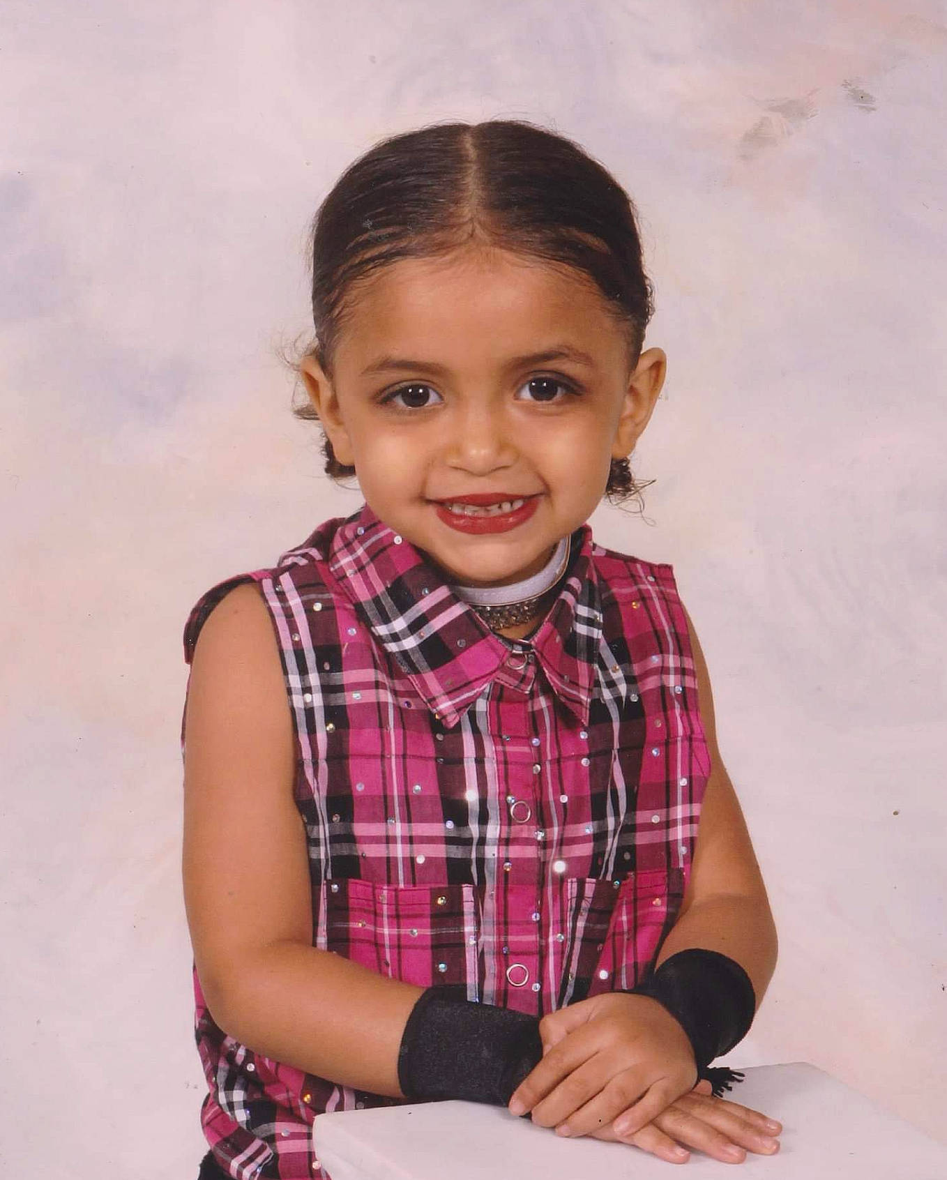 Cassandra is registered to the contest to win money with this photo: cheek, child, child_model, face, joy, lip, pattern, person, plaid, sitting, smile, toddler