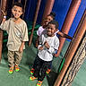 child, children, indoor_play_area, playground, smiling, happy, socks, casual_clothing, padded_poles, climbing_nets, fun, friends, group, boys, girl, play, leisure, colorful, active, posing