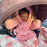 Ivry is registered to the contest to win money with this photo: baby, blanket, bundled_up, carriage, child, cozy, face, fluffy, hood, infant, outdoor, pacifier, pink_coat, plaid, portrait, safe, sitting, sleepy, stroller, travel