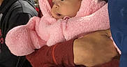Ivry is registered to the contest to win money with this photo: adult, baby, being_held, blanket, child, closeup, clothing, cozy, crowd, face, family, hood, infant, night, outdoor, photography, pink_outfit, portrait, snowsuit, storefront