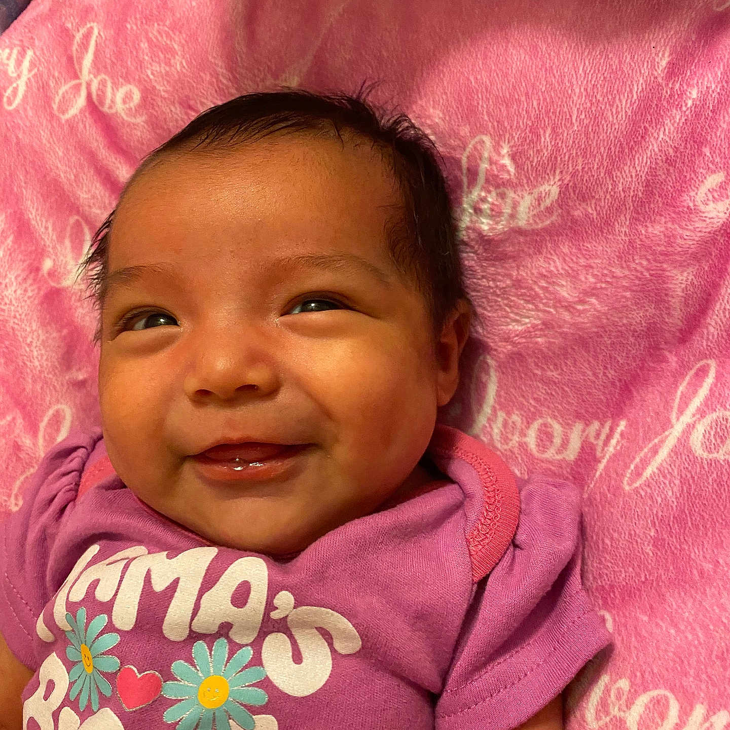 Ivry joined the competition — help win amazing prizes! adorable, baby, candid, child, close_up, cozy, dark_hair, face, floral_design, gummy_smile, happy, indoors, infant, lying_down, pink_blanket, portrait, purple_outfit, smiling, textile, warm_lighting
