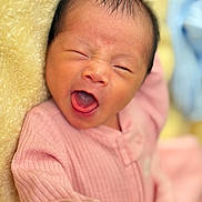 Anly is registered to the contest to win money with this photo: newborn, baby, infant, yawning, portrait, pink_outfit, blanket, close_up, face, eyes, mouth, soft_lighting, pastel_colors, cozy, lying_down, sleepy, cute, photography, head, indoor