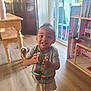 Jaylen is registered to the contest to win money with this photo: barefoot, cabinet, child, curtains, daylight, dollhouse, furniture, glass_jar, happy, home, indoor, person, shirt, shorts, smiling, table, toddler, toy_dog, window, wooden_floor