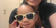 Jaylen joined the competition — help win amazing prizes! woman, toddler, child, sunglasses, smile, happy, indoor, tank_top, wild, person, portrait, face, black_hair, casual_clothing, fun, fashion, cute, family, joy, close_up