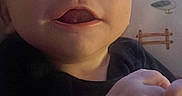 Zachary is registered to the contest to win money with this photo: baby, infant, child, portrait, face, smiling, happy, curious, indoor, bedroom, bedding, blanket, clothing, shirt, hands, eyes, mouth, close_up, sitting, home