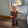 Isaac joined the competition — help win amazing prizes! toddler, child, indoor, wooden_floor, door, glass_door, sunlight, vest, sneakers, curious, standing, person, young_child, light, window, floor_mat, casual_clothing, daylight, home_interior, exploring