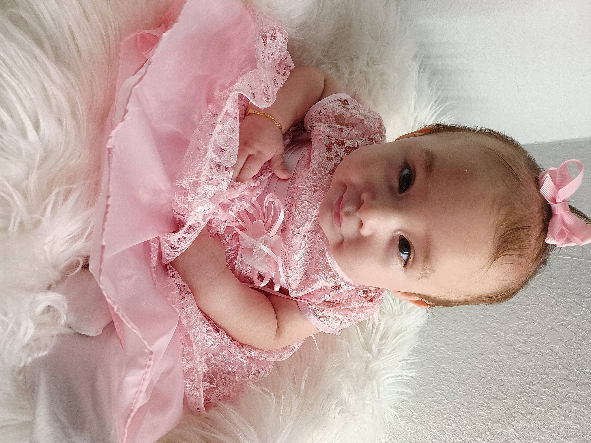 October is registered to the contest to win money with this photo: baby, baby_toddler_clothing, cheek, child, dress, embellishment, eyelash, finger, hair_accessory, hand, happy, headgear, headpiece, iris, lip, person, pink, skin, sleeve, smile