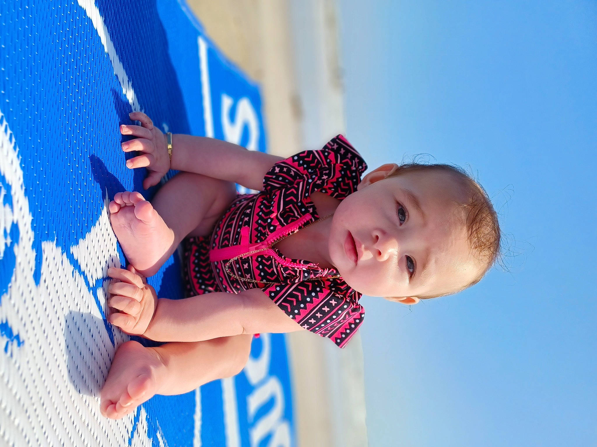 October is registered to the contest to win money with this photo: azure, baby, baby_toddler_clothing, blue, elbow, electric_blue, finger, fun, gesture, hand, happy, human_leg, leisure, nail, pattern, people_in_nature, person, sky, smile, toddler