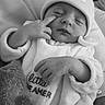 baby, infant, sleeping, beanie, hat, onesie, blanket, hand, face, cute, cozy, soft, clothing, newborn, peaceful, portrait, child, resting, indoor, black_and_white