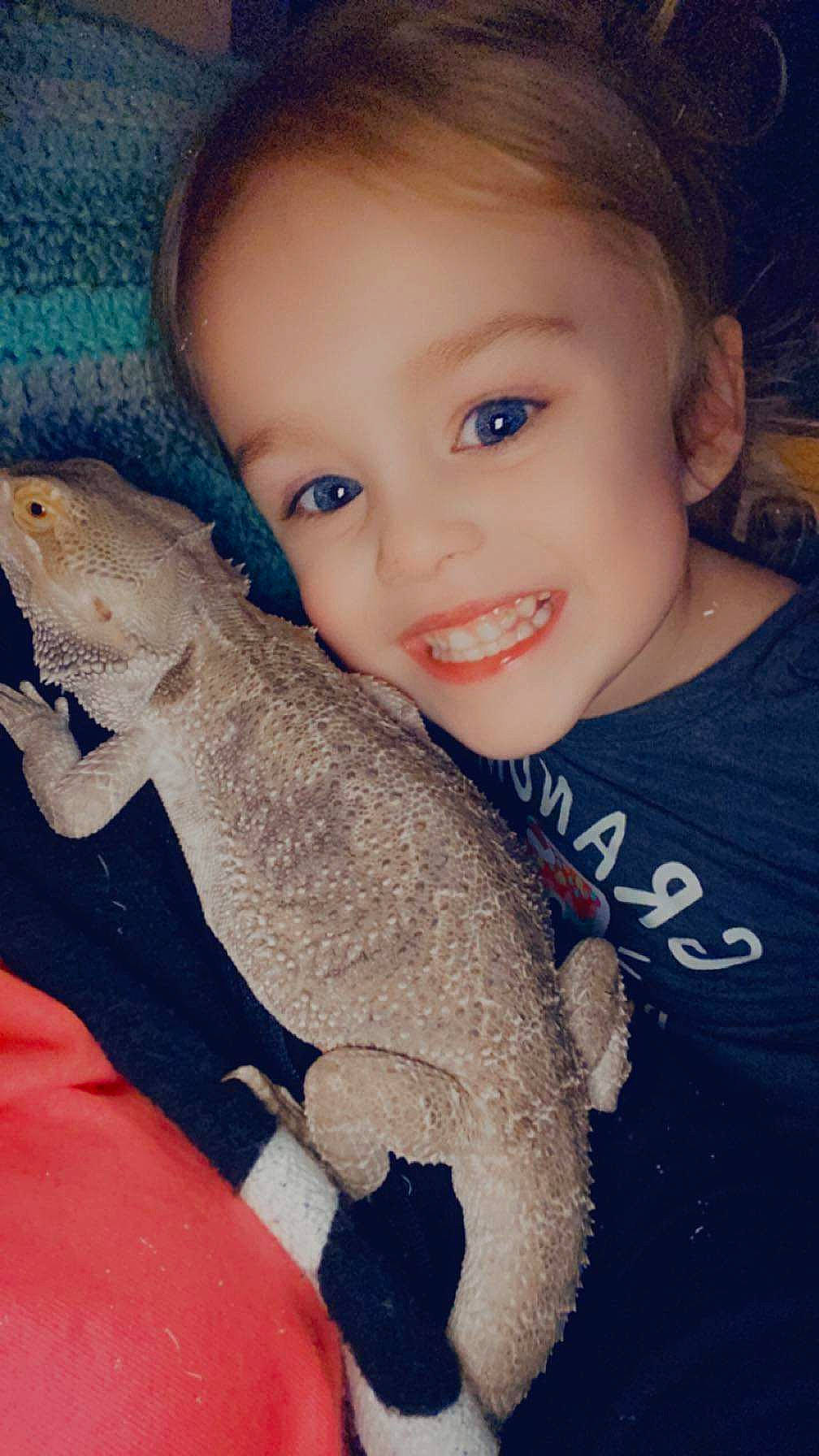 Breelynn is registered to the contest to win money with this photo: baby_toddler_clothing, electric_blue, eye, finger, flash_photography, hand, happy, iguania, joy, leg, lizard, mammal, mouth, nail, person, reptile, skin, smile, tail, terrestrial_animal
