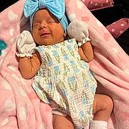 Oaklynn joined the competition — help win amazing prizes! newborn, baby, infant, smile, blue_bow, mittens, romper, pink_blanket, heart_pattern, sleeping, cute, soft_texture, cozy, child, portrait, white_socks, resting, peaceful, indoors, adorable