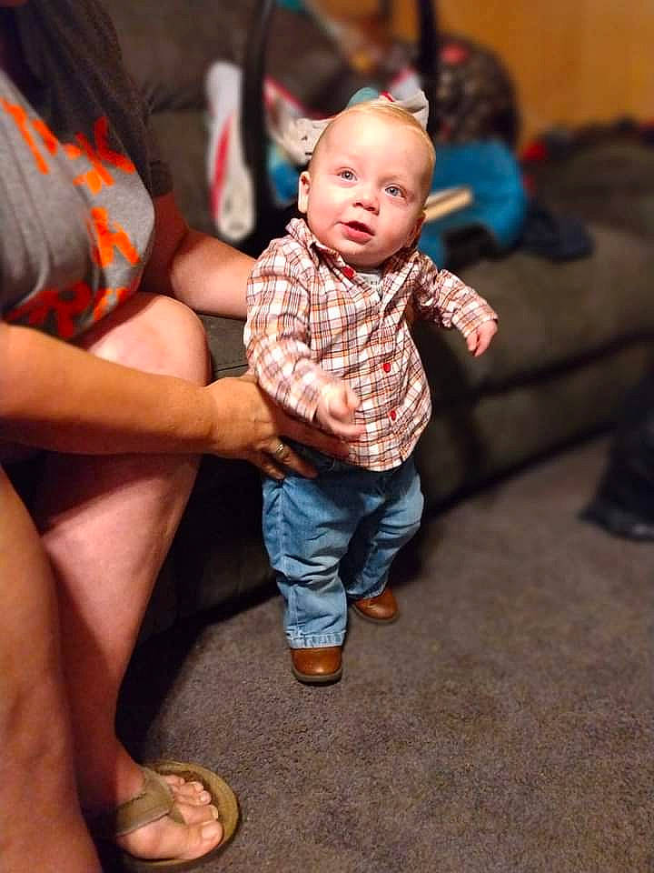 Allen is registered to the contest to win money with this photo: baby, baby_toddler_clothing, child, event, eye, finger, flooring, foot, fun, gesture, happy, human_leg, leg, person, sandal, sitting, skin, standing, thigh, toddler