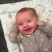 Jaxon joined the competition — help win amazing prizes! baby, infant, smile, onesie, zebra_pattern, cute, happy, lying_down, soft_mat, cloud_pattern, fist, small_hands, face, cheeks, indoor, carpet, child, expression, joy, portrait