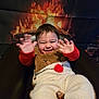 baby, child, smiling, waving, reindeer_outfit, fuzzy_clothing, chair, fireplace, holiday, cozy, warm, indoor, cute, happy, person, portrait, infant, seasonal, festive, background
