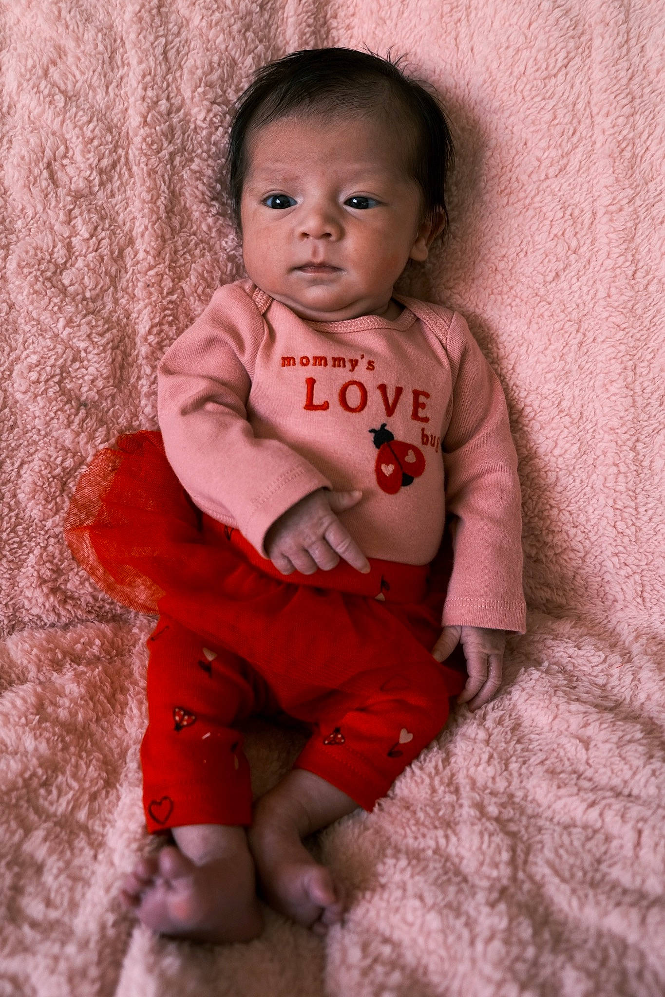 Lillian is registered to the contest to win money with this photo: baby, baby_toddler_clothing, cheek, child, chin, eye, face, flash_photography, happy, linens, lip, nose, person, pink, skin, sleeve, smile, standing, t_shirt, toddler