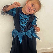 Mia participe au concours pour gagner de l'argent avec cette photo : child, toddler, costume, dress, blue, black, smile, happy, posing, boots, floor, wall, young, fun, cute, indoor, person, fashion, footwear, joyful