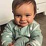 baby, child, smiling, face, hand, cozy, onesie, mint_green, cloud_pattern, cushion, floor, wooden_floor, drawer, furniture, indoors, portrait, cute, happy, toddler, young_child