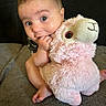 Charli is registered to the contest to win money with this photo: baby, child, stuffed_animal, plush_toy, pink, soft, cute, sitting, hand, face, expression, indoor, couch, furniture, foot, clothing, comfort, toy, infant, portrait