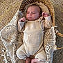 baby, sleeping, basket, knitted_clothing, crochet_blanket, woven_mat, infant, peaceful, cozy, hands, feet, texture, soft_lighting, indoor, portrait, newborn, relaxation, natural_colors, fabric, comfort