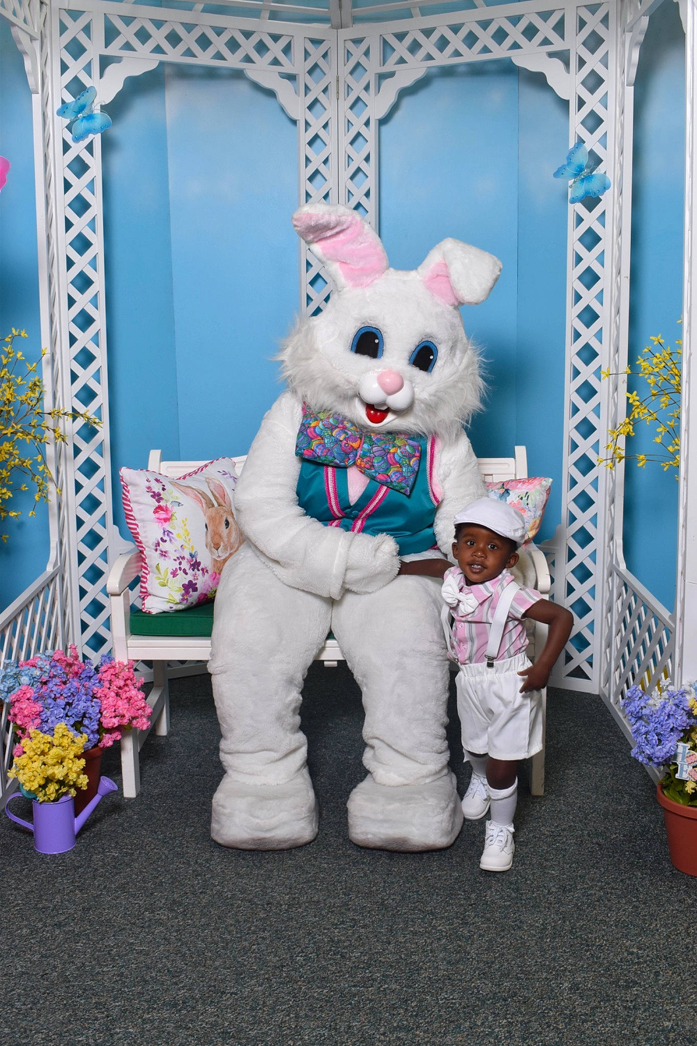 Reginald is registered to the contest to win money with this photo: art, blue, costume, event, felidae, fictional_character, flowerpot, fur, headwear, houseplant, mascot, person, pink, plant, plush, purple, room, stuffed_toy, tail, toy