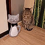 tabby_cat, knitted_cat, stuffed_toy, bow_tie, wooden_floor, indoor, wall, bamboo_wallpaper, pet, animal, feline, decor, sitting, cute, companion, domestic_cat, striped_cat, flooring, relaxed, house