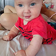 Cody joined the competition — help win amazing prizes! baby, infant, child, blue_eyes, red_shirt, crawling, bed, person, indoor, smile, cheeks, skin, hand, arm, face, clothing, people, young, cute, human