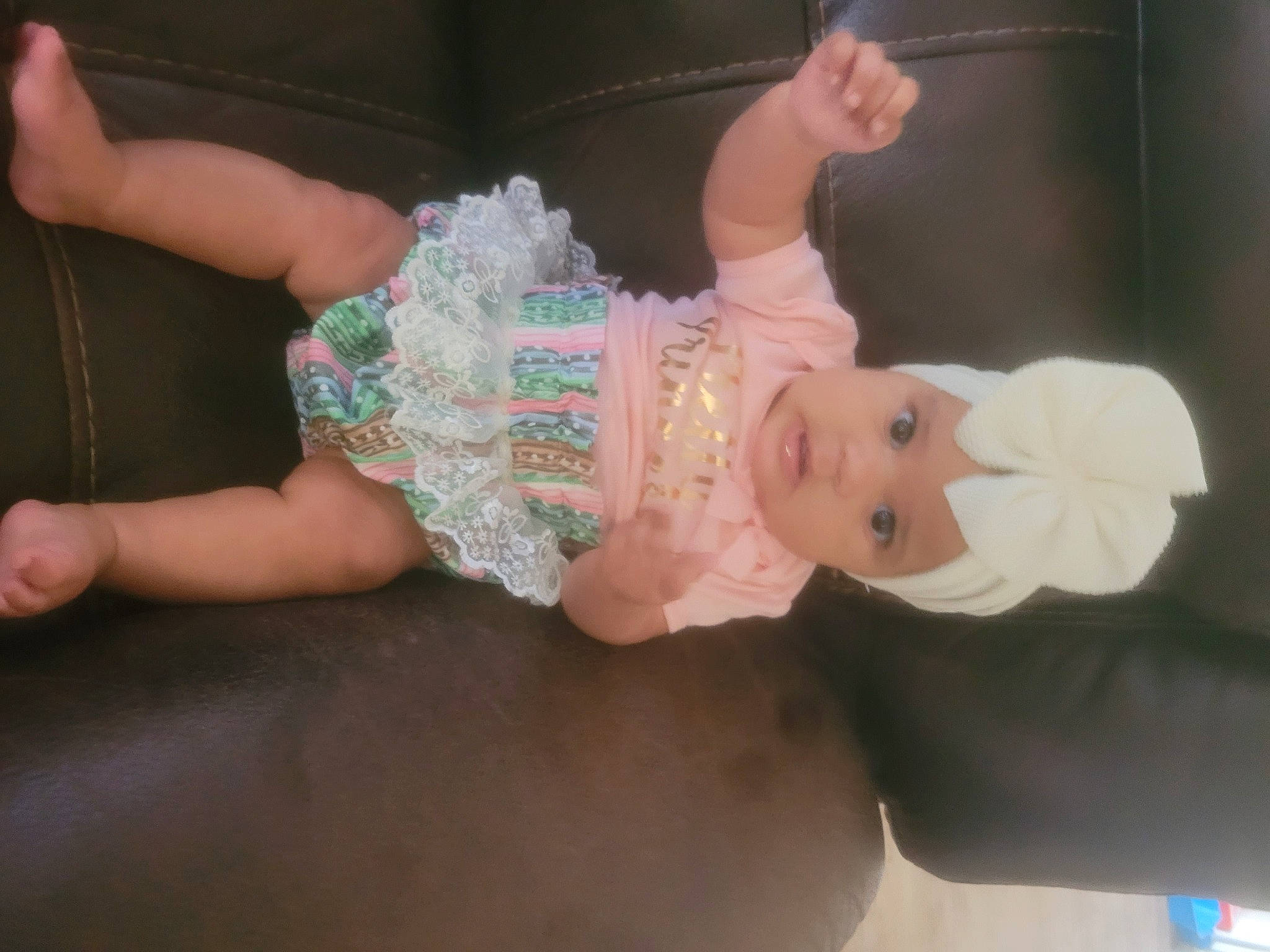 Mariah is registered to the contest to win money with this photo: baby, baby_products, baby_toddler_clothing, cheek, child, embellishment, finger, gesture, hand, headwear, nail, pattern, person, pink, product, skin, sleeve, sock, textile, thumb