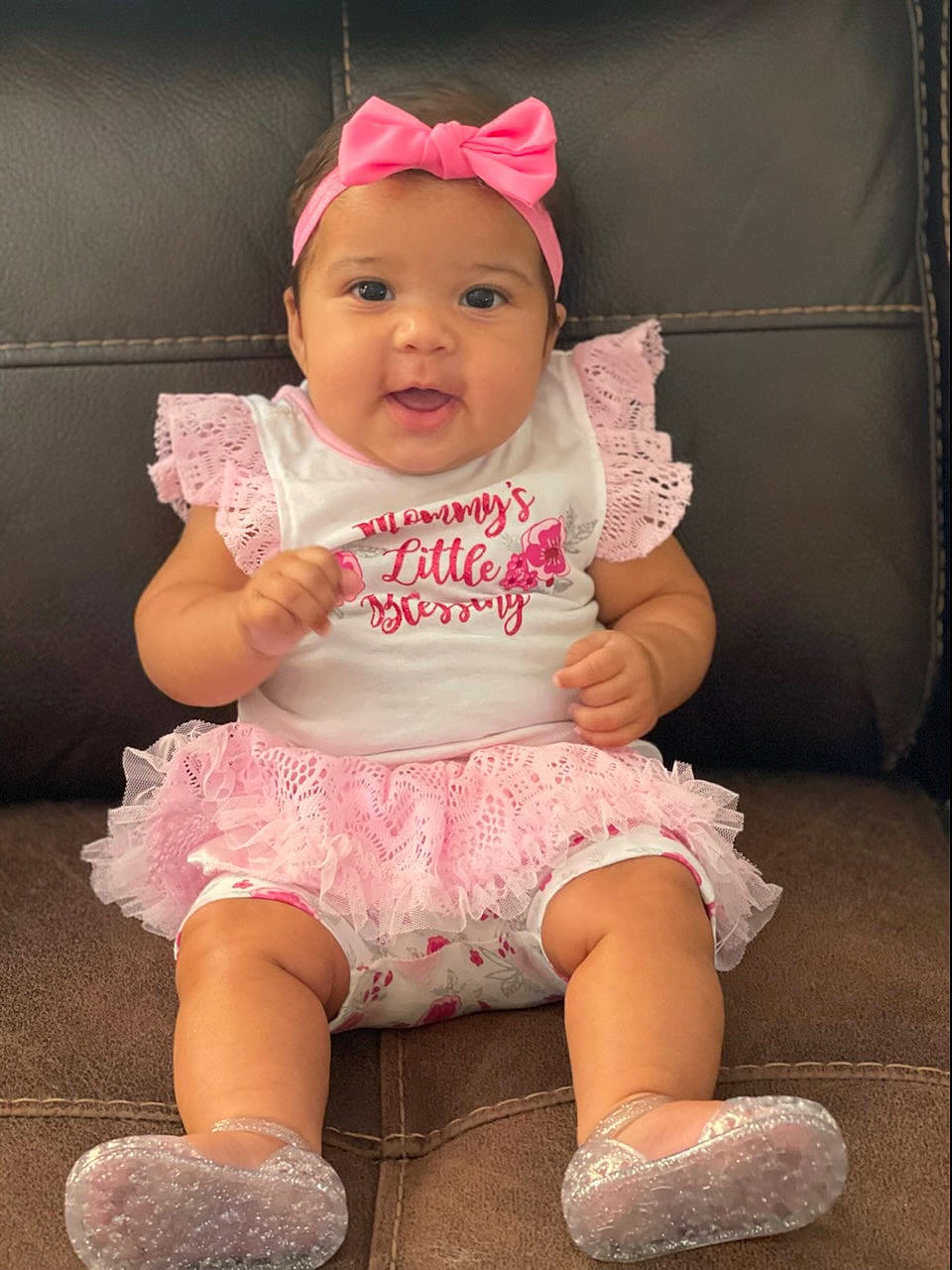 Mariah is registered to the contest to win money with this photo: baby, baby_toddler_clothing, cap, cheek, child, comfort, happy, headwear, leg, magenta, mouth, person, pink, purple, shoe, sitting, skin, sleeve, smile, thigh