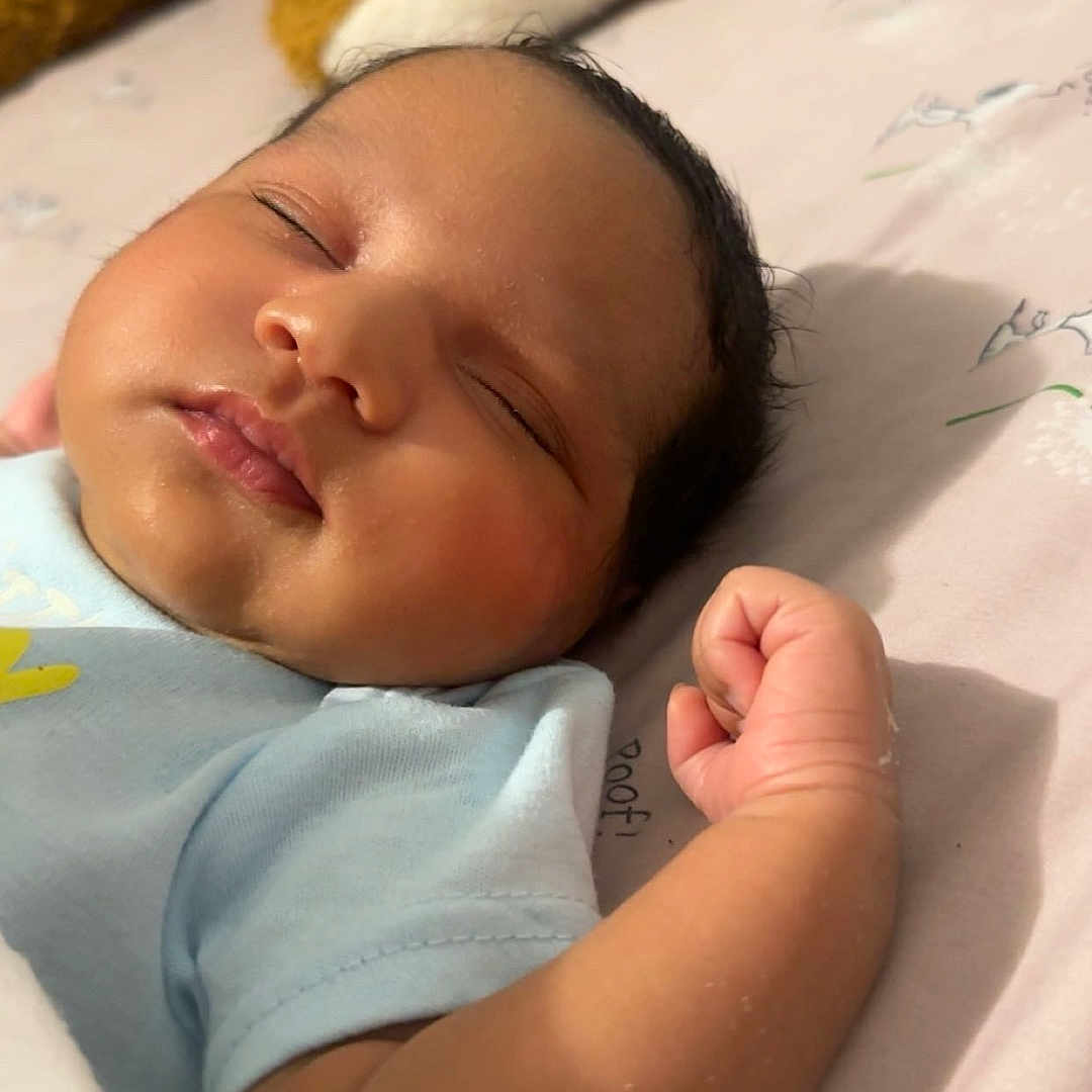 Ehlani Berenice is registered to the contest to win money with this photo: baby, bed, blanket, blue_shirt, child, closeup, clothing, cute, face, fist, hand, indoors, infant, newborn, peaceful, rest, skin, sleeping, soft_toy, teddy_bear