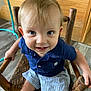 Houston Lane is registered to the contest to win money with this photo: toddler, child, blue_eyes, smiling, sitting, wooden_chair, indoor, wooden_floor, wooden_wall, blue_shirt, striped_shorts, cute, person, baby, young_child, happy, portrait, casual_clothing, furniture, holding