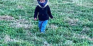 Houston Lane is registered to the contest to win money with this photo: adventure, casual_clothing, child, daylight, field, footwear, grass, green, headgear, helmet, jacket, nature, outdoor, pants, person, playful, scenery, trees, walking, young