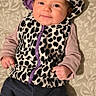 baby, child, infant, portrait, smiling, sitting, leopard_print, hood, hat, clothing, purple, pants, cushion, fabric, pattern, indoors, closeup, happy, date_stamp, full_body