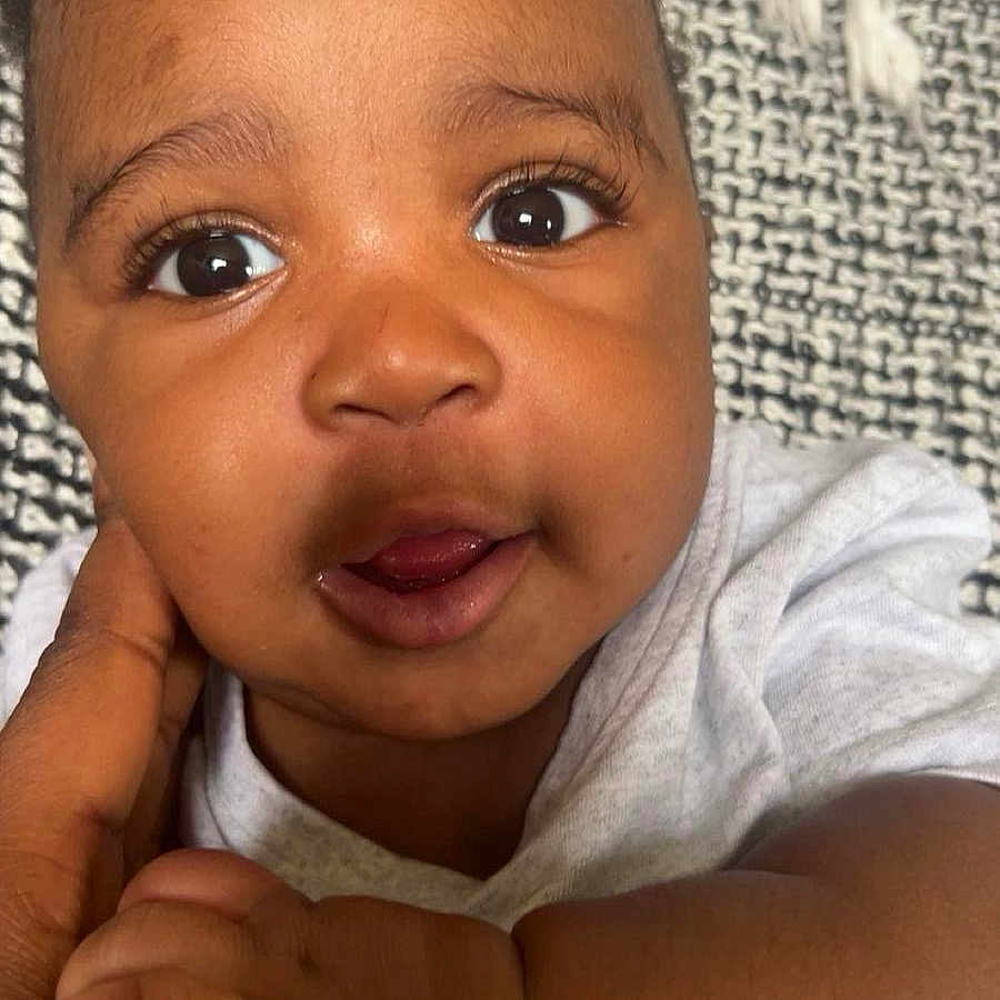 Sefu is registered to the contest to win money with this photo: baby, blanket, child, closeup, clothing, curious, cute, expression, eyes, face, hand, holding, infant, person, portrait, skin, small, texture, toddler, young