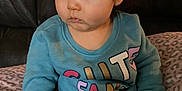 Meredith is registered to the contest to win money with this photo: baby, biting, blackhair, brownhair, clothing, crawling, face, hair, head, pants, person, photography, portrait, sitting, sleeve, spitting