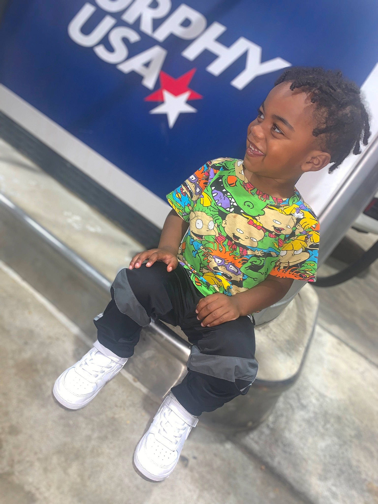 Jeremiah is registered to the contest to win money with this photo: boot, child, electric_blue, event, fashion_design, fun, happy, human_leg, joy, knee, leg, leggings, leisure, logo, person, recreation, sitting, sock, sportswear, t_shirt