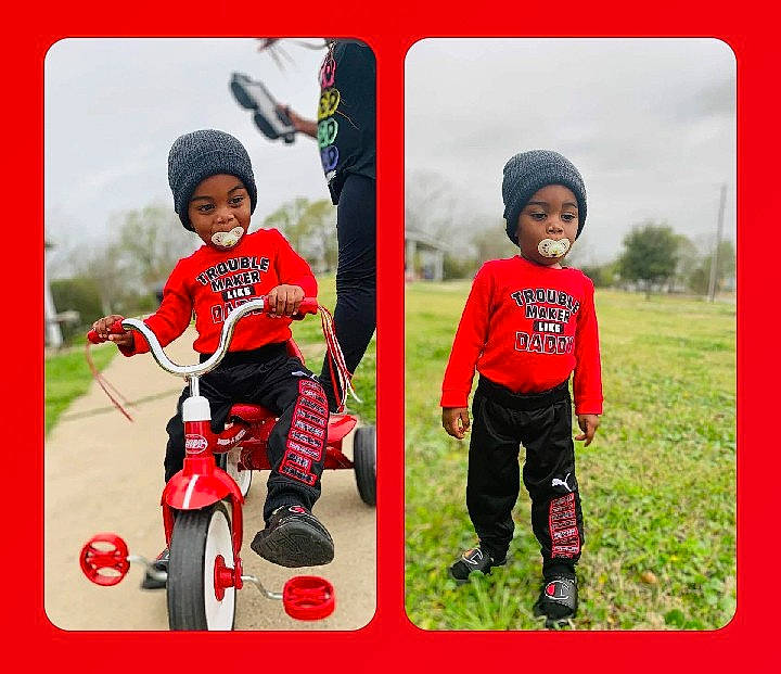 Jeremiah is registered to the contest to win money with this photo: baby_toddler_clothing, bicycle, bicycle_accessory, child, fun, grass, happy, headwear, leisure, magenta, people_in_nature, person, plant, play, recreation, sky, smile, sports_equipment, tire, toddler