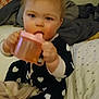 Allison is registered to the contest to win money with this photo: baby, bed, blanket, bottle, chewing, child, cozy, cute, heart_pattern, holding, indoor, infant, pajamas, person, pillow, sippy_cup, sitting, sleepwear, soft_toys, young_child