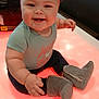 Allison is registered to the contest to win money with this photo: baby, boots, casual, chair, child, clothing, cute, footwear, glowing_surface, happy, headband, indoor, infant, light, person, pink_headband, portrait, sitting, smiling, table