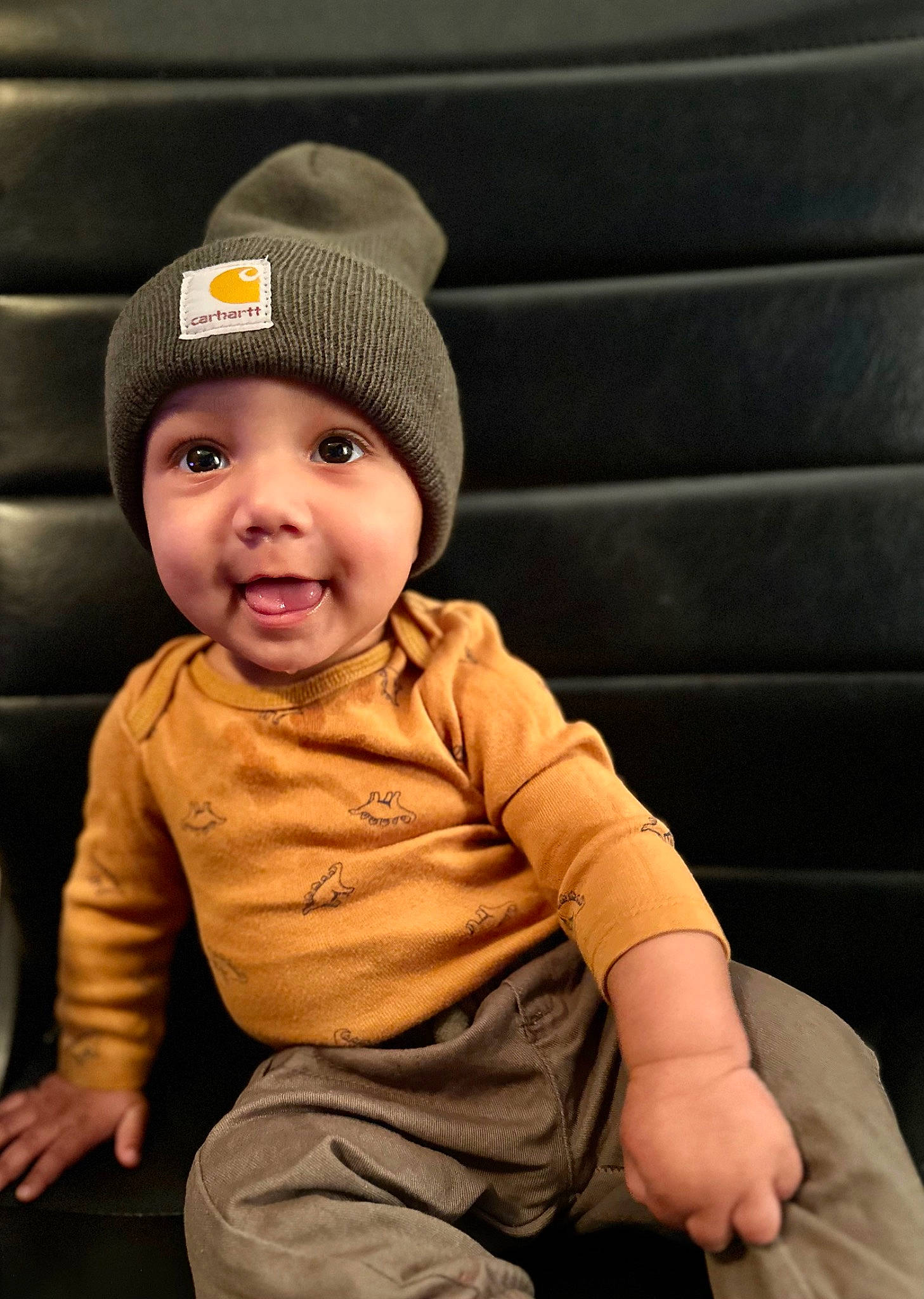 Lennox is registered to the contest to win money with this photo: baby, baby_toddler_clothing, beanie, cap, cheek, child, eye, fashion_accessory, flash_photography, flooring, fun, happy, hat, headgear, headwear, person, portrait_photography, sitting, sleeve, t_shirt